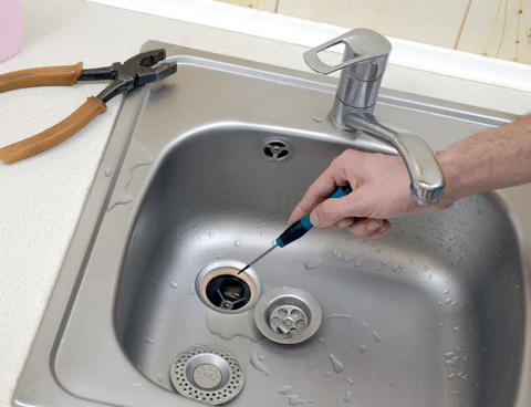 plumber repairing drain