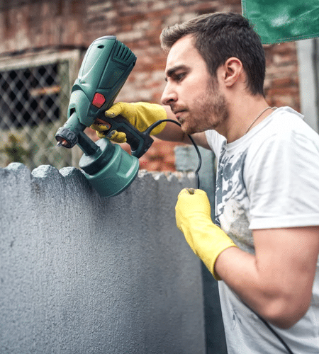 profesional construction worker painting the wall