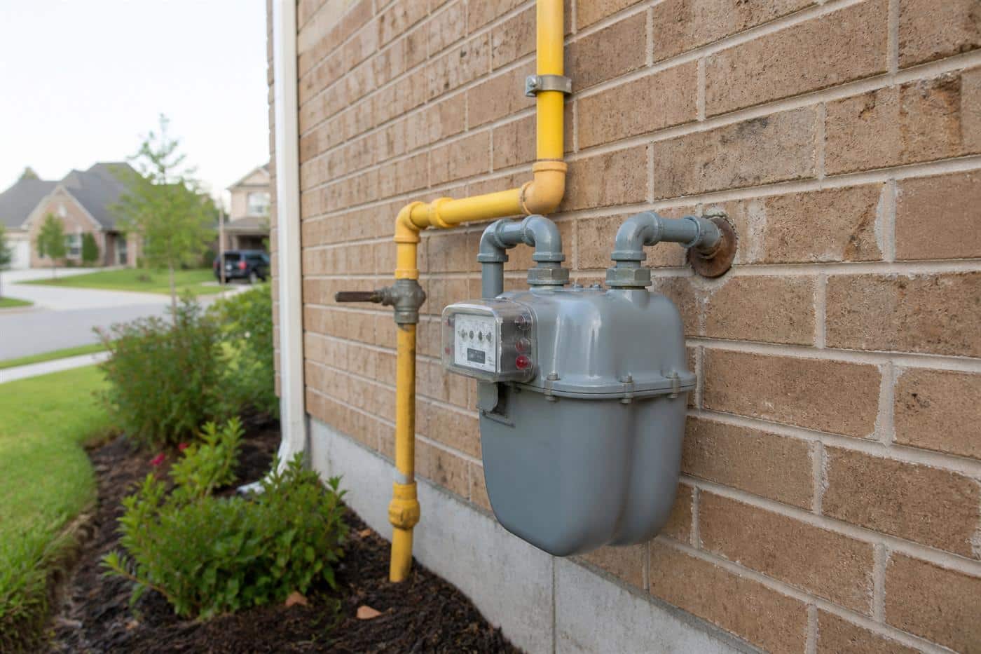 Residential gas meter and supply line on a Dallas-area home